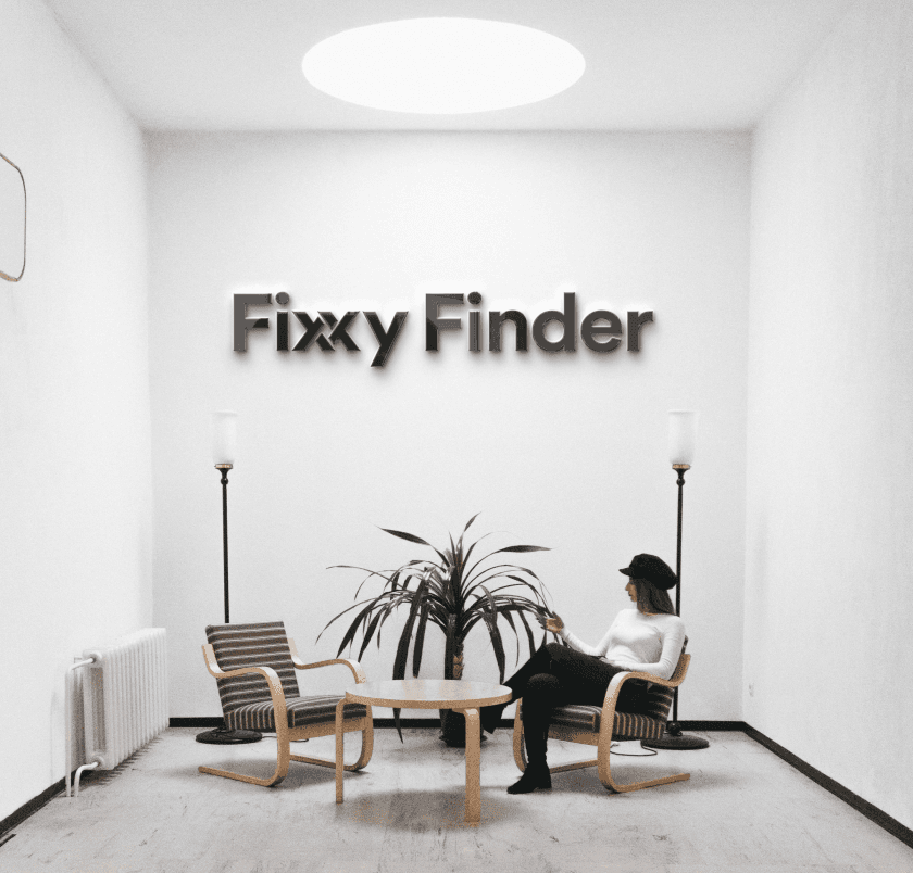 Fixxy Finder wordmark mounted on a white interior wall